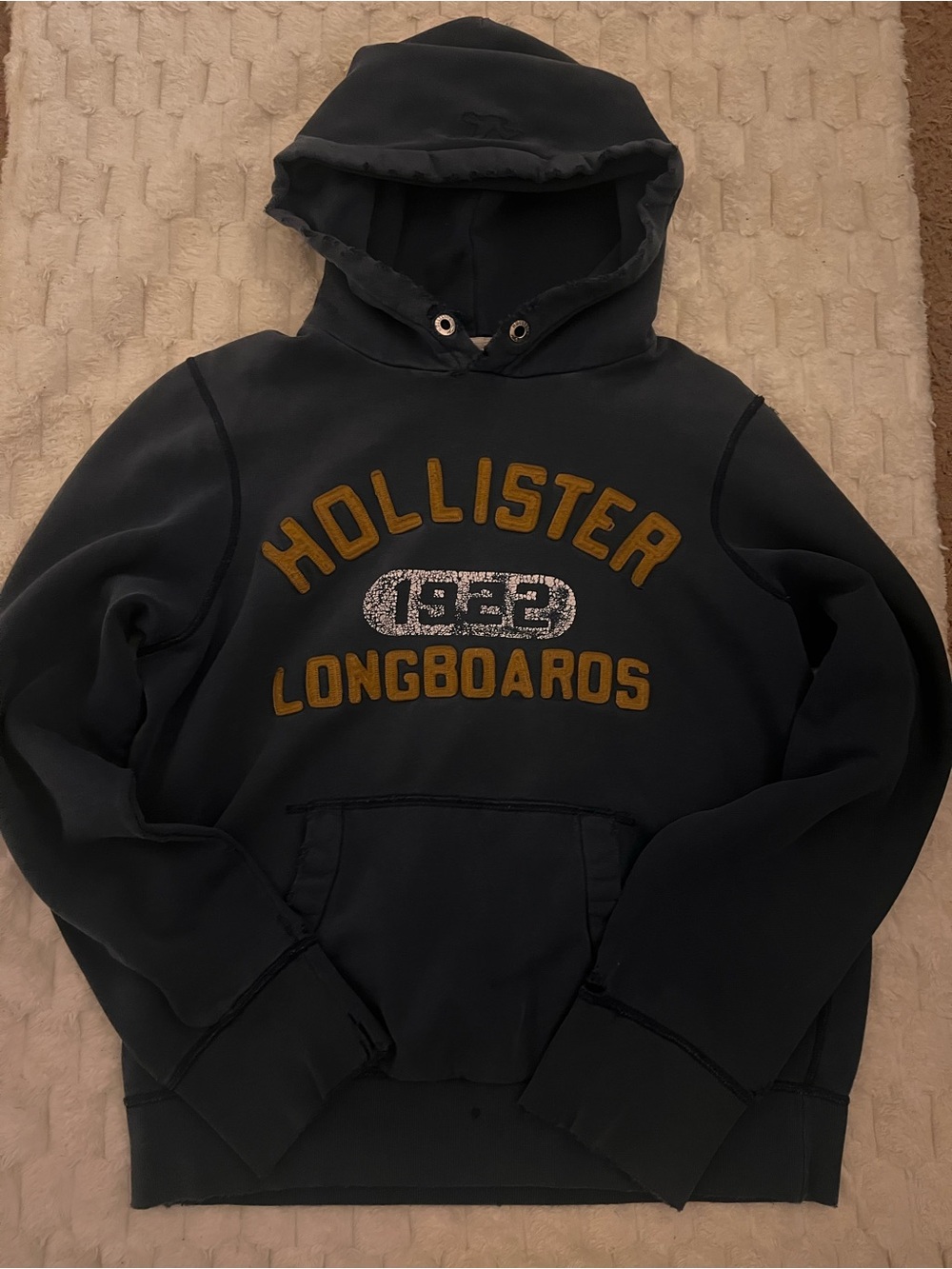 Vintage Hollister Men's Navy Hoodie with Gold Longboards Logo